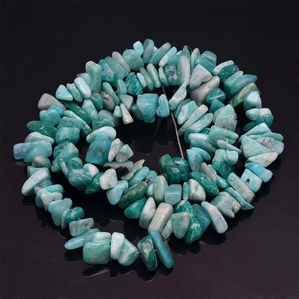 A circular strand of light blue to turquoise natural stone agate beads used for DIY jewelry making.