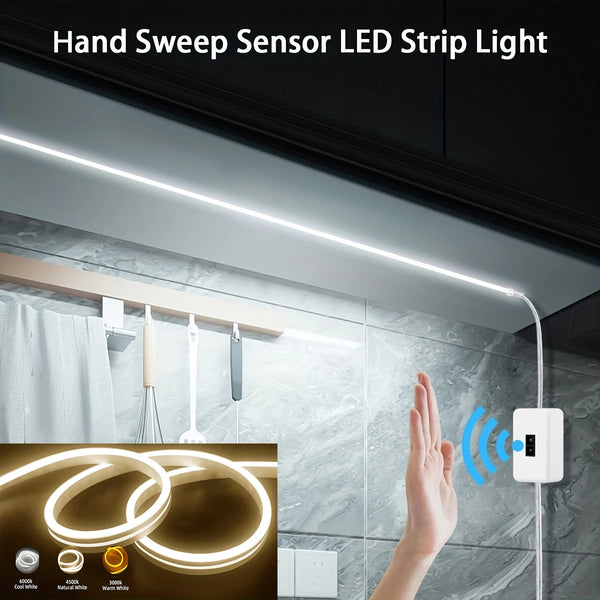 Hand sweep sensor LED strip light illuminating a kitchen backsplash with a hand gesture