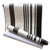 Decorative vinyl wall strips featuring vertical black and white stripes rolled up.
