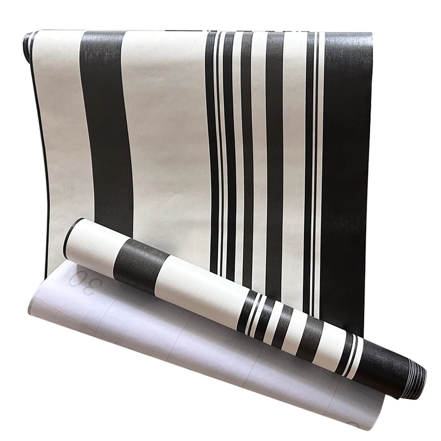 Decorative vinyl wall strips featuring vertical black and white stripes rolled up.