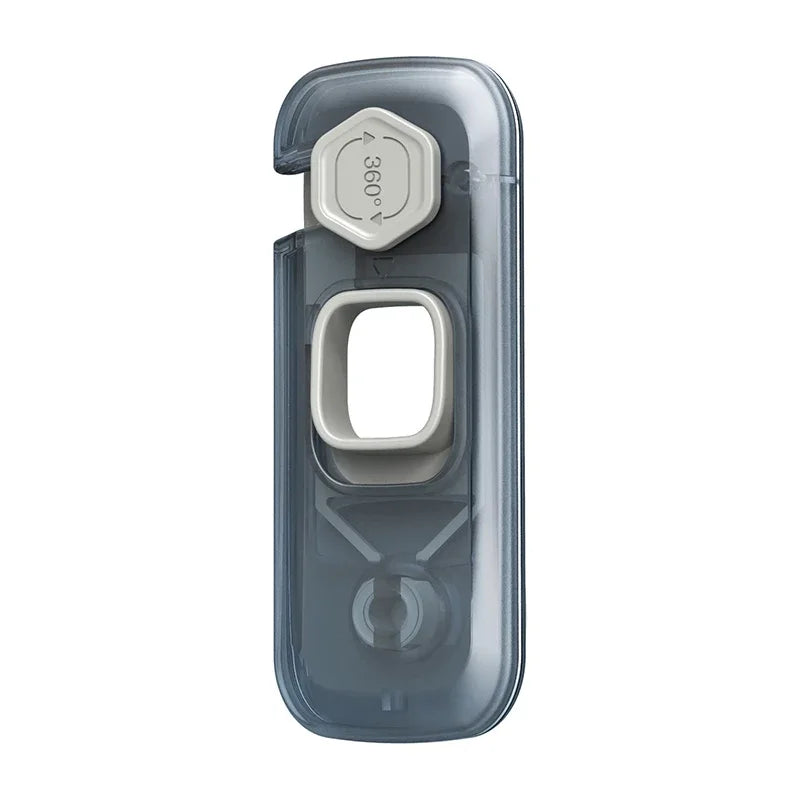 A clear plastic toddler cabinet safety lock set with a hexagonal opening and a round cutout.