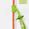 A close-up of a green and yellow auxiliary rope knot attached to a red rope, used for outdoor descent protection.