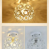 A crystal LED chandelier lamp with a multifaceted globe design hanging from a ceiling.