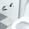 A white shower grab bar and handrail mounted on a tiled wall next to a toilet.