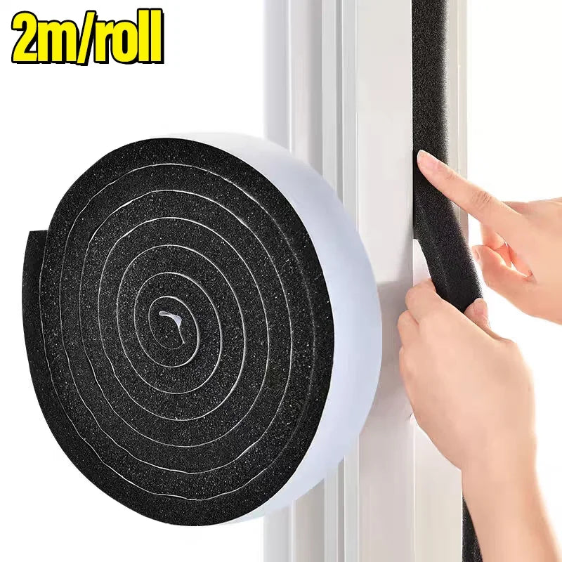 A hand is pulling a black foam window sealing strip onto a white window frame.