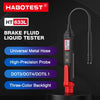 A portable digital brake fluid tester labeled HT 633L with a metal hose and three-color backlight.