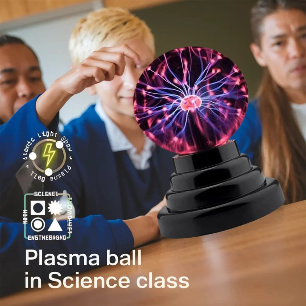 A student in a science class is holding a glowing purple plasma ball light device.