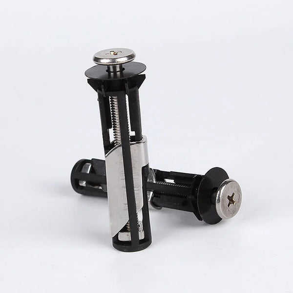 A close-up view of stainless steel toilet seat hinge bolts with black and silver components.