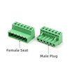 A female seat and a male plug of a solderless docking terminal block connector in green.