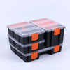 A stack of black and clear plastic hardware organizer boxes with orange accents.