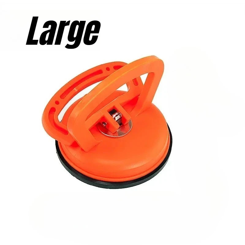An orange heavy-duty suction cup dent puller tool for auto body repair.