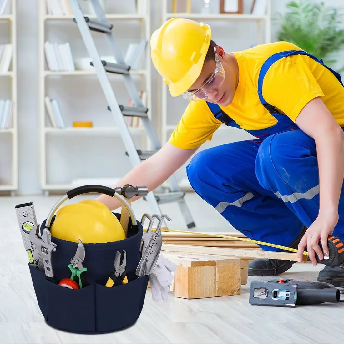 A construction worker wearing a yellow hard hat and safety glasses is using a large folding storage organizer basket to hold 