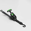 Black retractable ratchet tie-down strap with a green handle for cargo securing