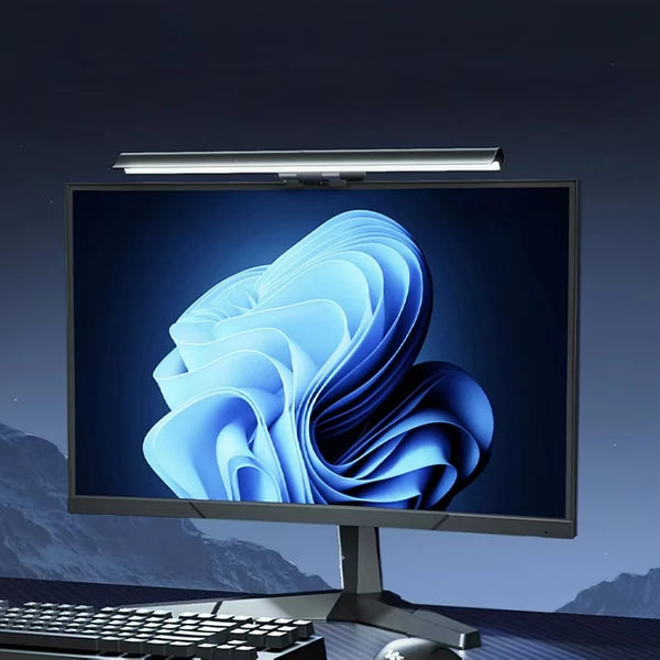 A computer monitor displaying a blue, wavy graphic, illuminated by an adjustable LED light bar.