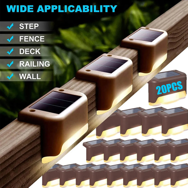 A variety of solar powered deck and pathway lights in brown and black are shown mounted on a wooden railing.
