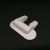 A white universal adhesive door latch designed for child safety, shown in a close-up view.