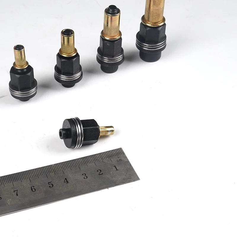 A set of precision hand rivet nuts in various sizes and finishes displayed next to a ruler.