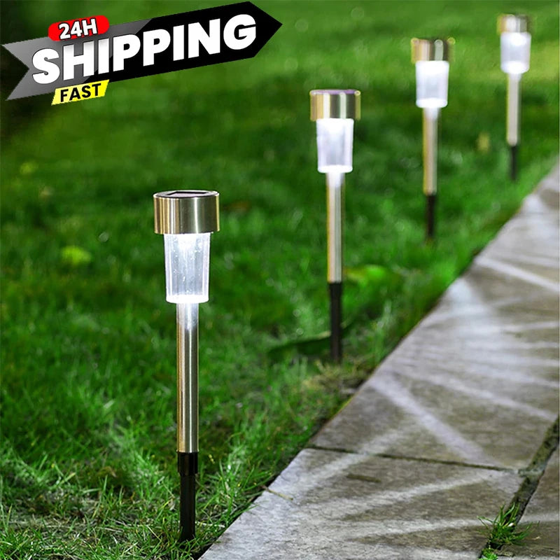 A row of solar garden path lights with illuminated white bulbs lining a paved walkway in a grassy area.