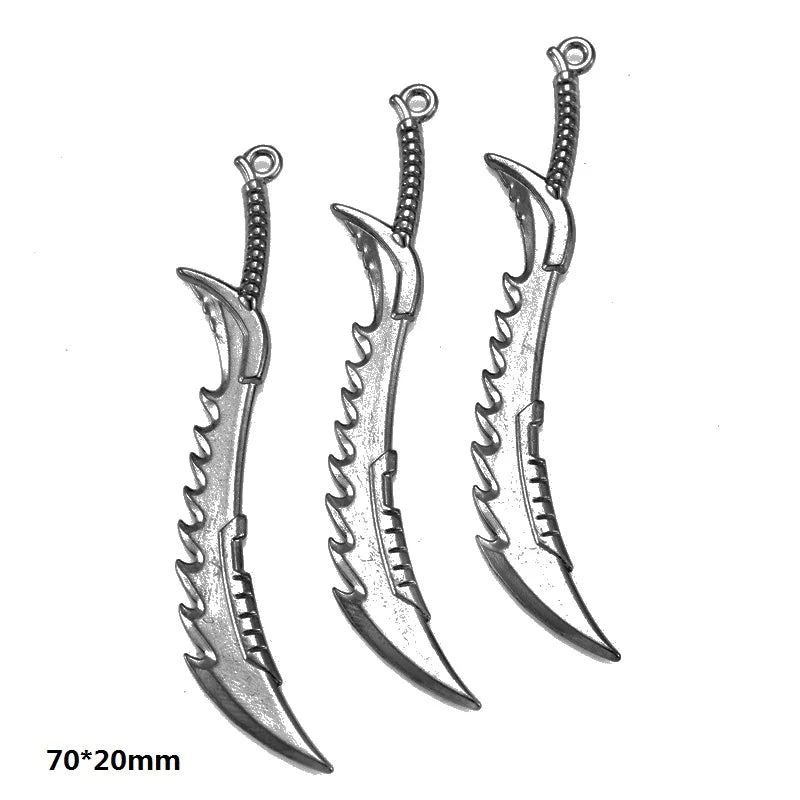 A set of three silver-toned alloy charms shaped like stylized knives or blades for DIY jewelry making.
