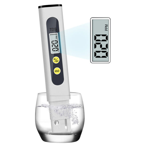 A digital water quality tester device with a display showing TDS and PPM, placed in a glass of water.