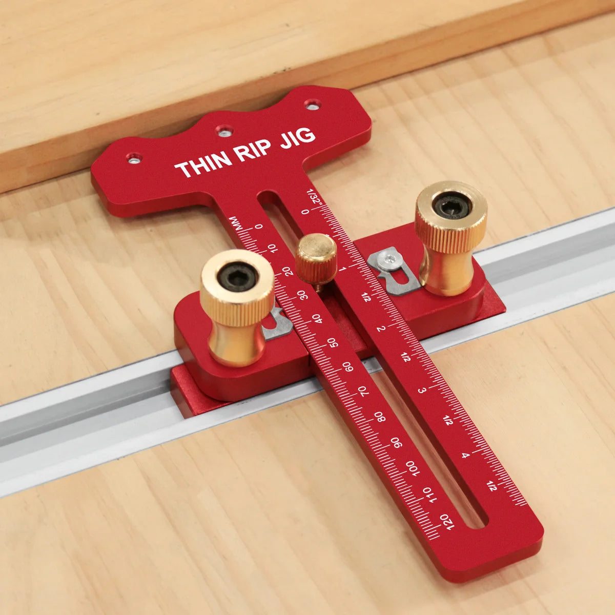 A red precision thin rip jig for a table saw, featuring a sliding scale and measuring markings.