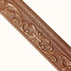 Close-up of a brown, textured, ornamental wall trim decal with a baroque scroll pattern.