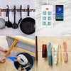 A collection of various tools and a roll of double-sided mounting tape are displayed on a white surface.