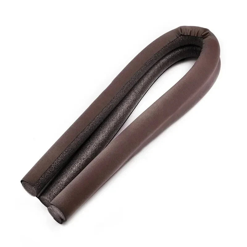 A dark brown windproof door draft excluder seal strip rolled into a tube.