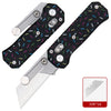 A black utility knife with a colorful patterned handle and silver blade shown from the side.