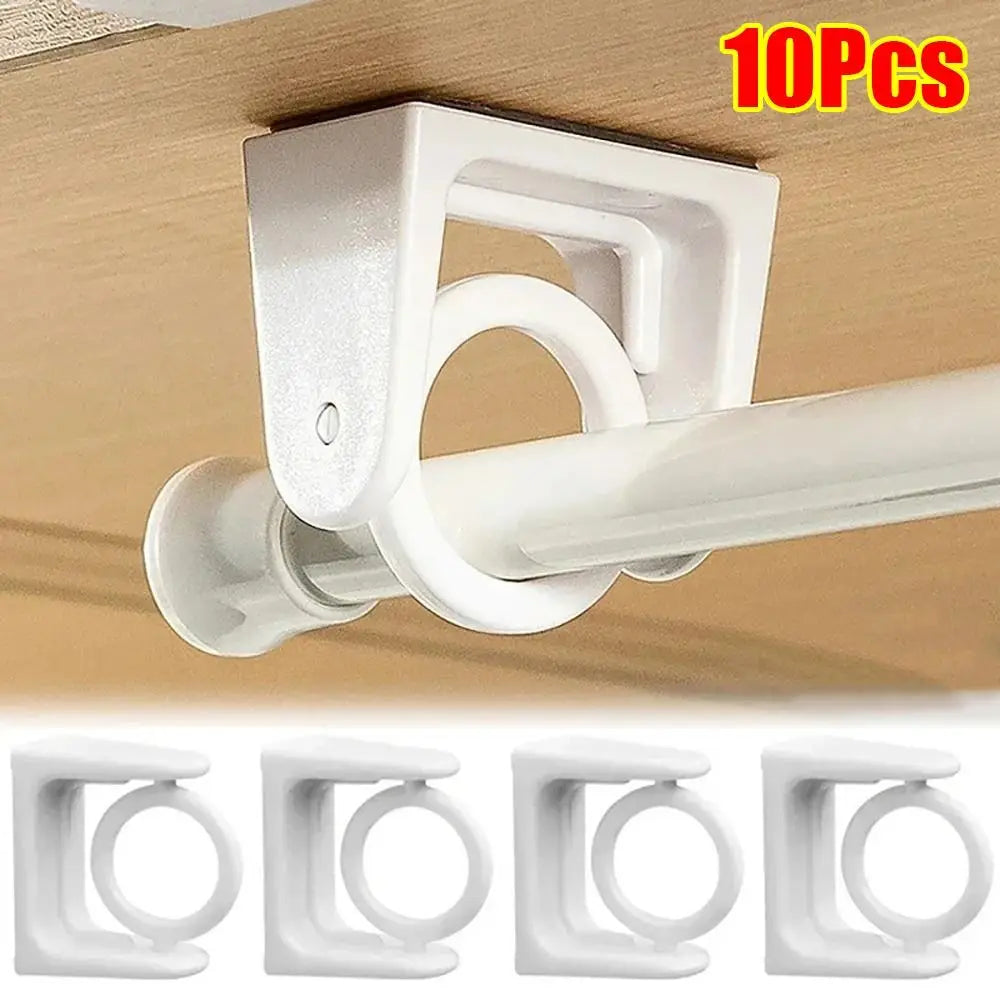 Ten pack of white 360 degree rotating adhesive curtain rod brackets mounted on a wooden surface.