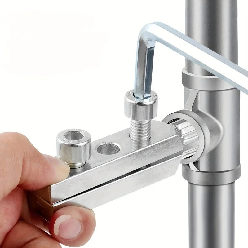 A hand is using a precision pipe extractor tool to remove a faucet or valve component from a metal pipe.