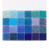 A tray of colorful acrylic rice beads in various shades of blue and green for DIY jewelry making