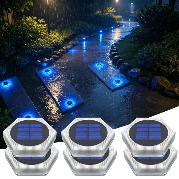 Four heavy duty solar deck lights with motion sensors are shown illuminating a wet pathway in a garden setting.
