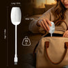 A white dual-mode USB projection lamp is shown next to a brown leather bag, illustrating its dimensions and size.