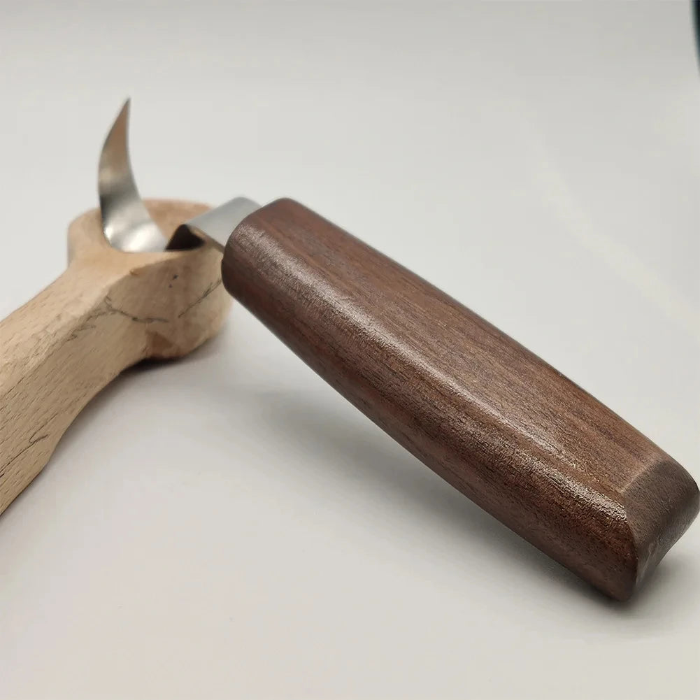 A wooden carving tool with a metal blade is shown next to its handle.