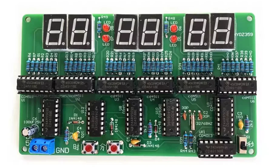 A green electronic circuit board featuring multiple digital displays and components for a DIY digital clock kit.