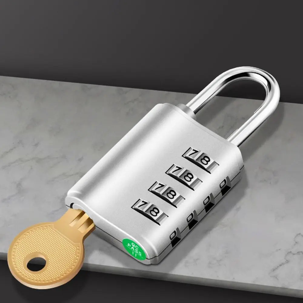 A silver heavy duty combination lock with a key, resting on a gray marble surface.