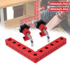 A set of red precision right angle fixing clamps and a measuring ruler are shown in use.