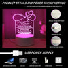 A decorative night light shaped like a heart with a message, powered by a USB cable.