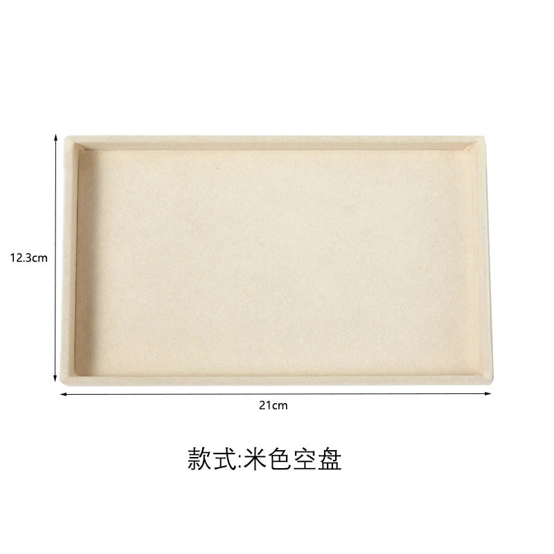 A rectangular, light beige plush velvet jewelry storage tray with dimensions 21cm by 12.3cm.
