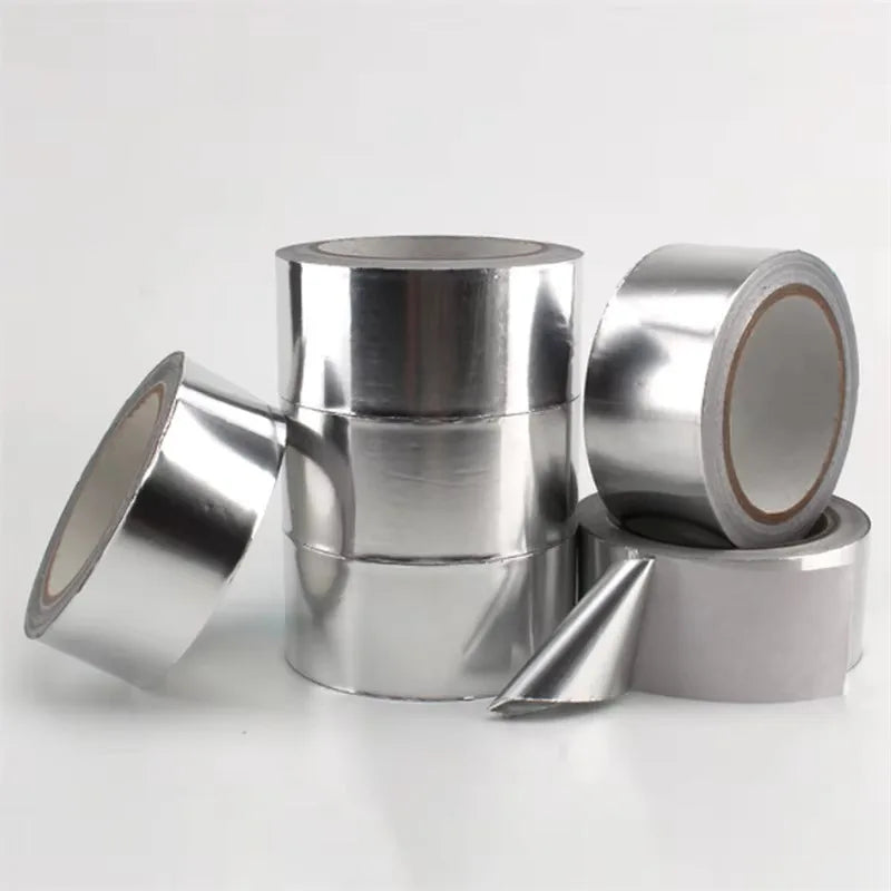 Silver aluminum foil tape in various rolls and a cut piece for pipe and leak sealing