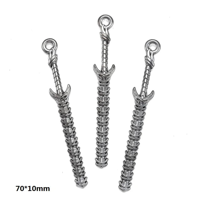 Three silver alloy charms with looped tops and twisted bodies for DIY jewelry making