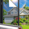 Roll of self-adhesive privacy window film shown in a window frame with a suburban house visible outside