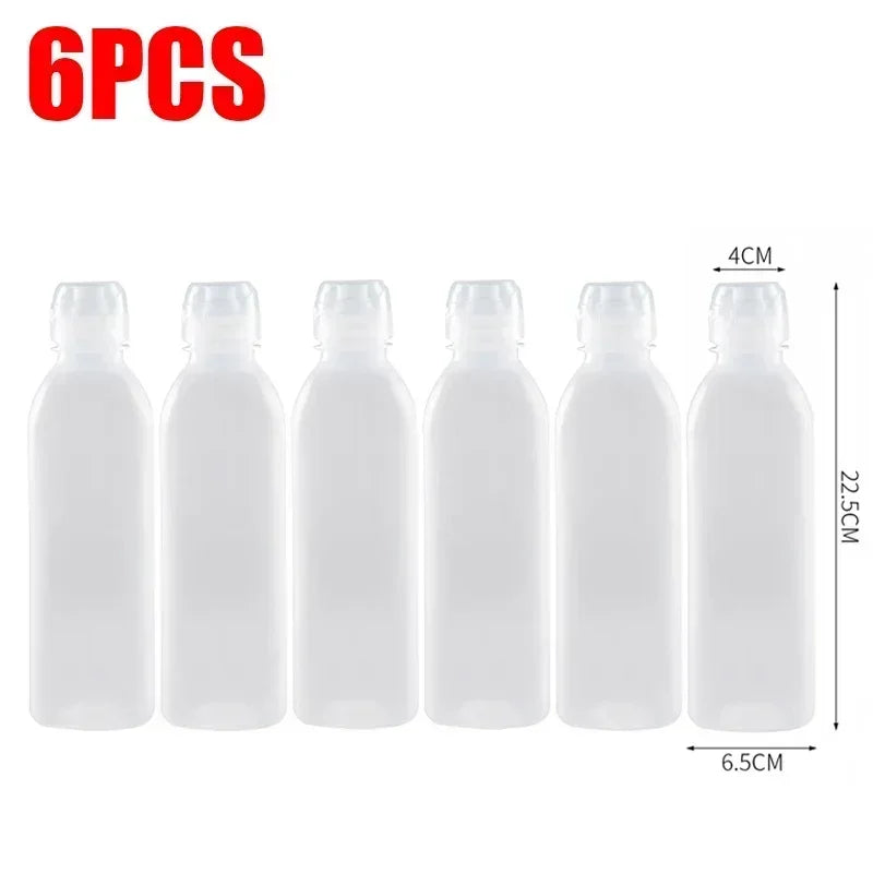 Six clear squeeze dispenser bottles for kitchen seasoning with dimensions 4cm high and 6.5cm wide.