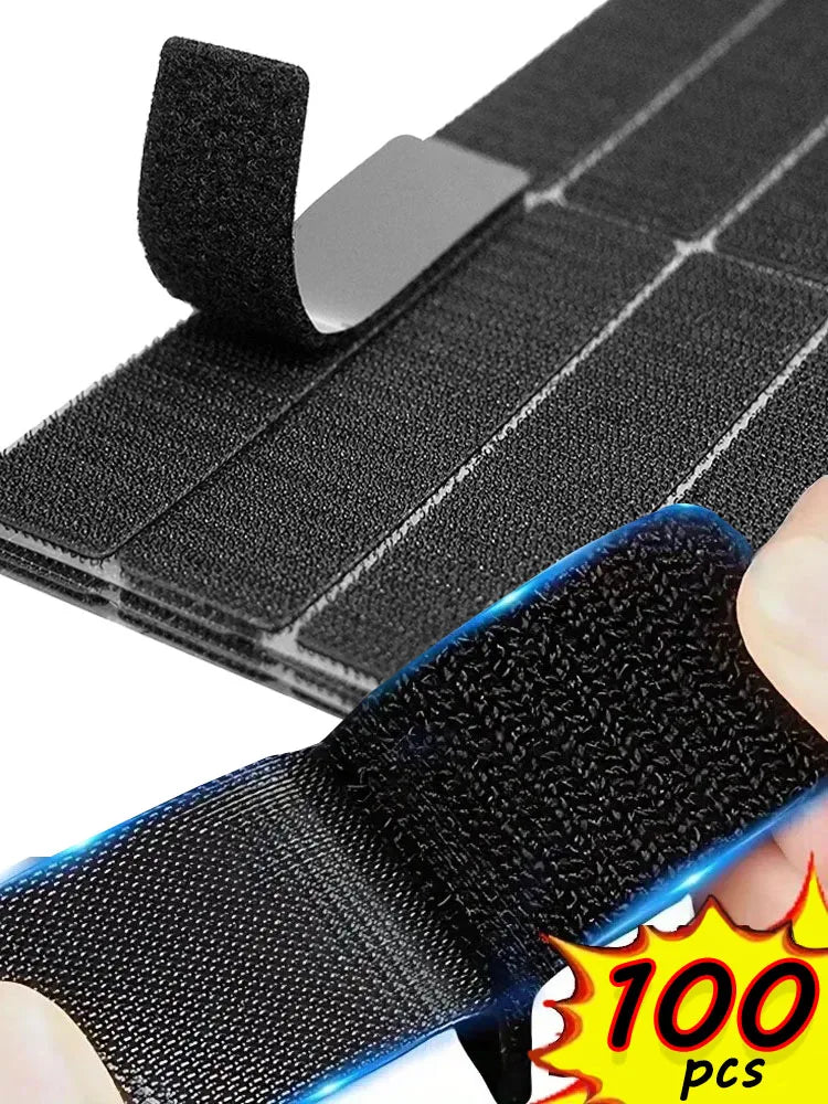 Black hook and loop carpet fixing tape with a double-sided hook and adhesive patch being applied to a surface.