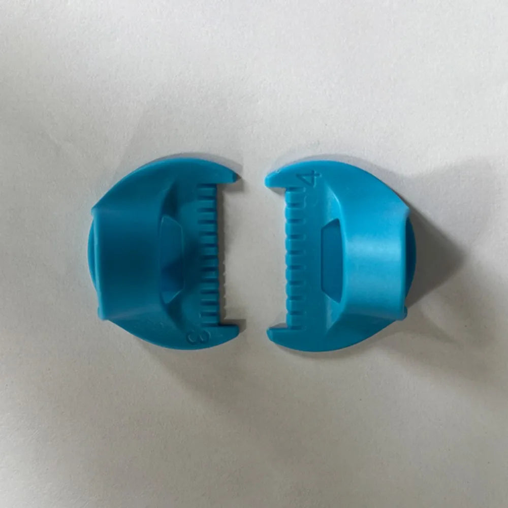 A pair of teal plastic templates for hand sewing edge lockstitch stitches.