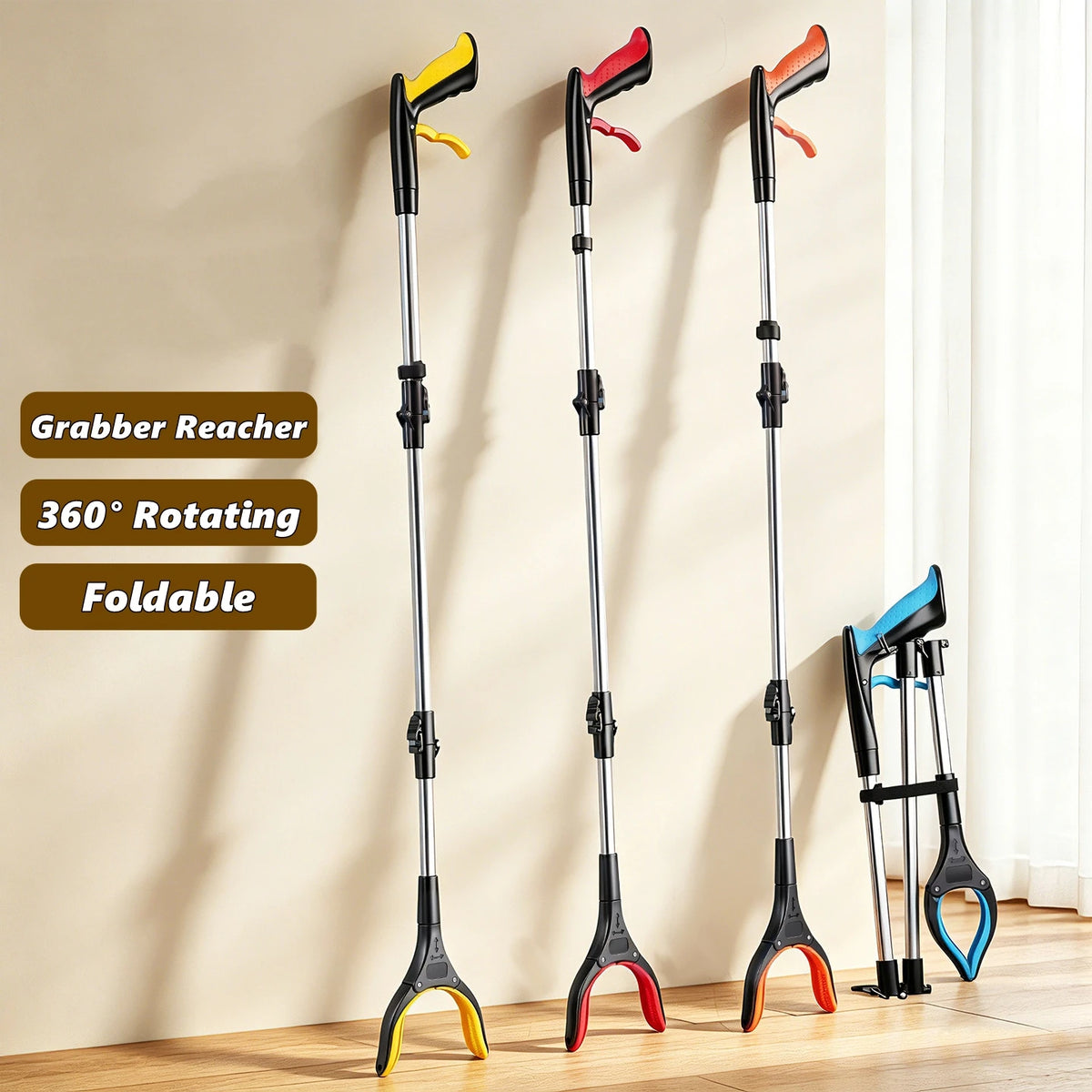 Three black grabber reacher tools with yellow and red tips displayed against a light wall.