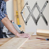A person uses a precision 3-point center finding tool to mark an 'X' pattern on a wooden board.
