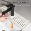 A black faucet drainer pad is shown being used to facilitate faster draining in a sink.