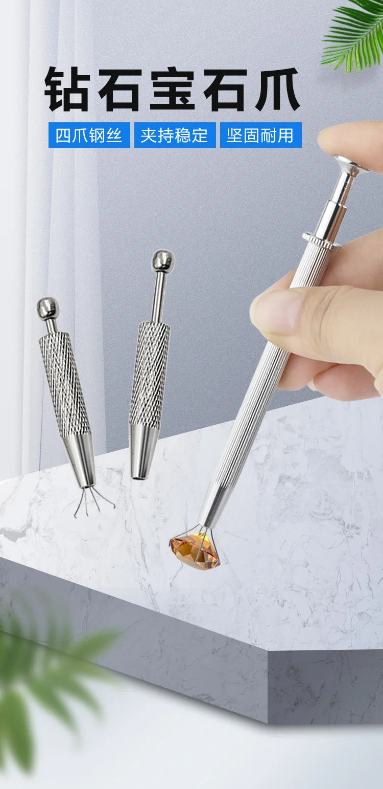 A hand holds a silver precision diamond gripper tool, showing its fine tip and textured shaft against a marble background.